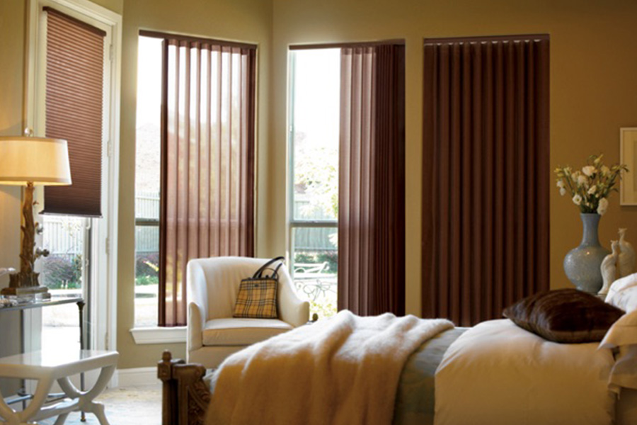 Choose durable and high-quality fabric or vinyl vertical blinds in Atlanta. Maroon fabric vertical blinds inside a bedroom