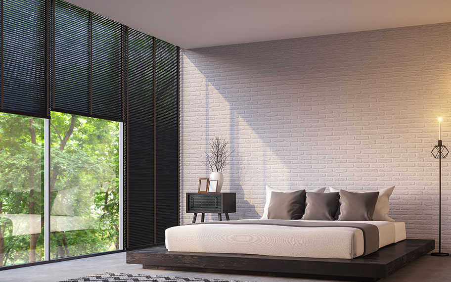 Get sleek lines when you choose roller shades vs. cellular shades in Atlanta. roller shade in a modern bedroom